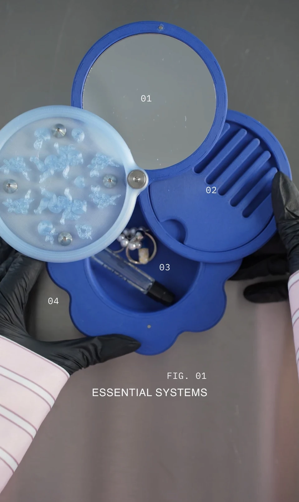 The apparatus unfolded to show its round mirror, removable comb and a compartment holding small objects.