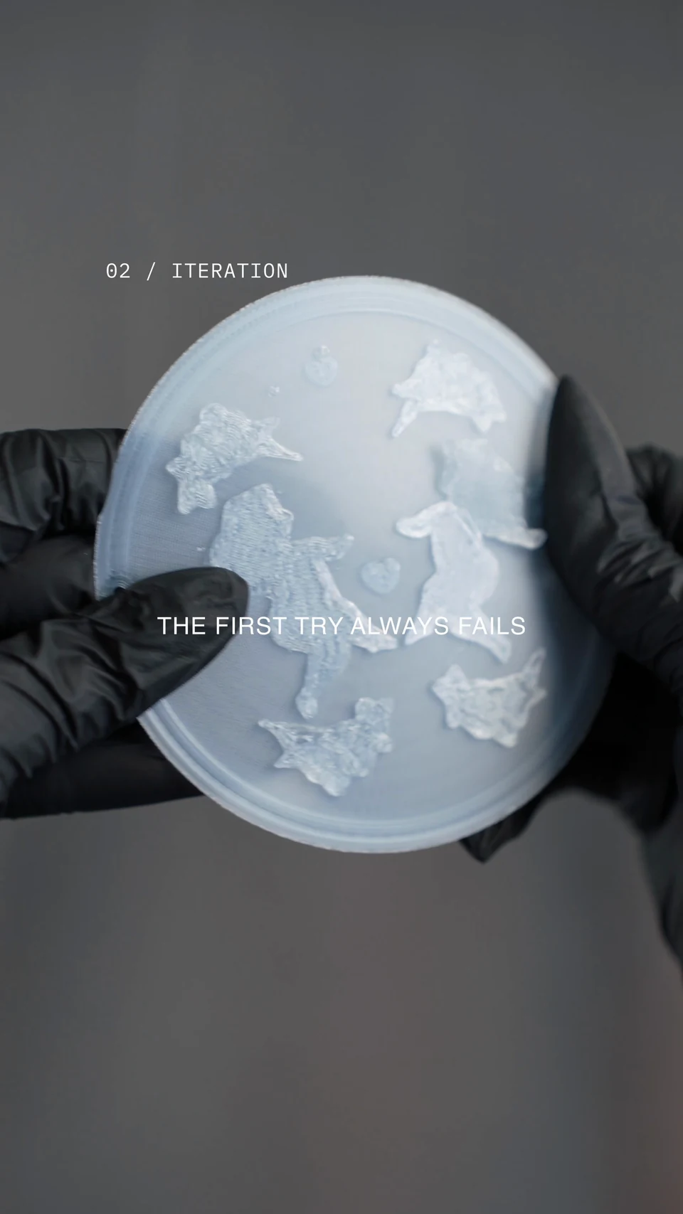 An early translucent printed cover, held in a black-gloved hand.