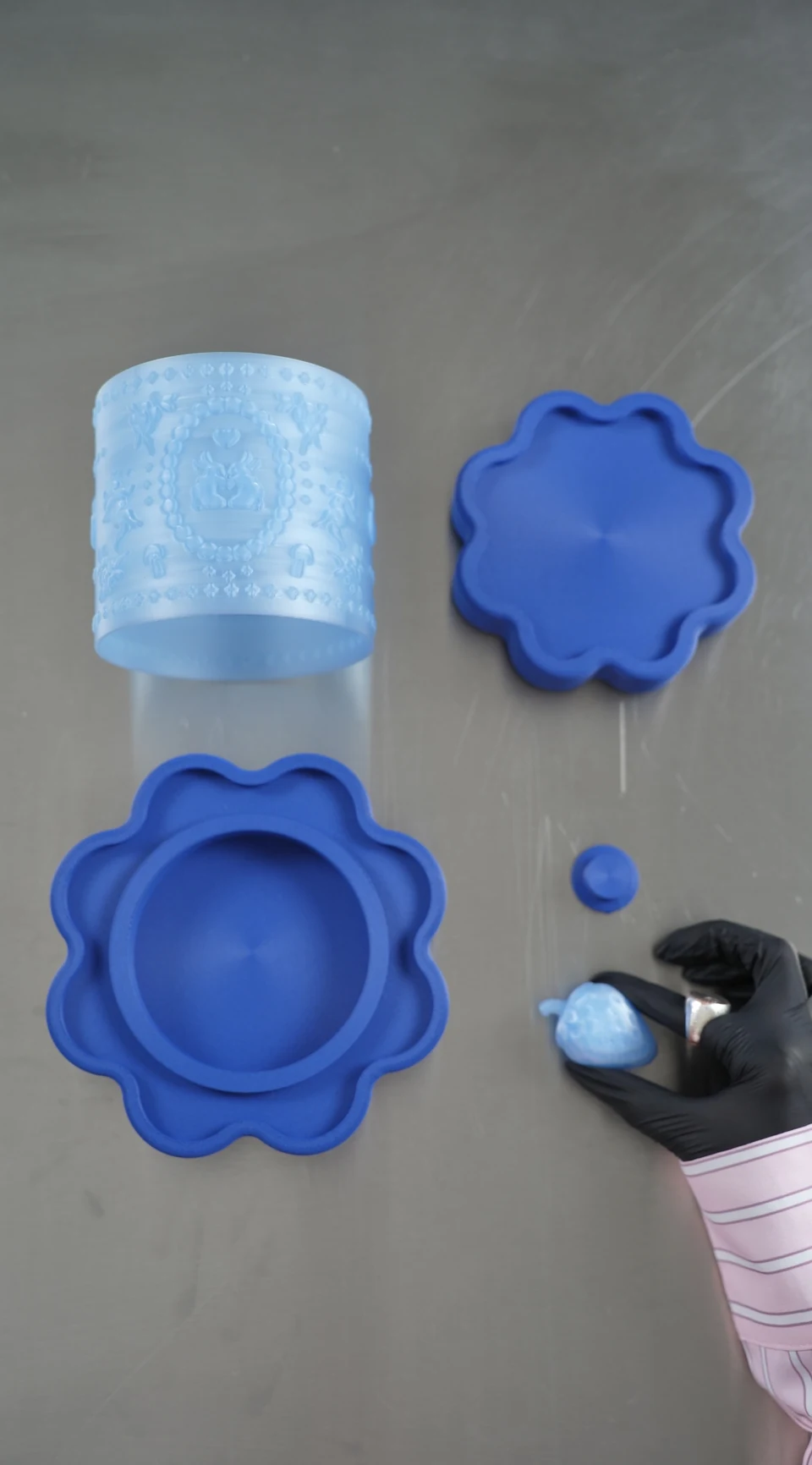 The physical Treasure Box components arranged for assembly: a translucent body, blue trays, a lid and a handle.