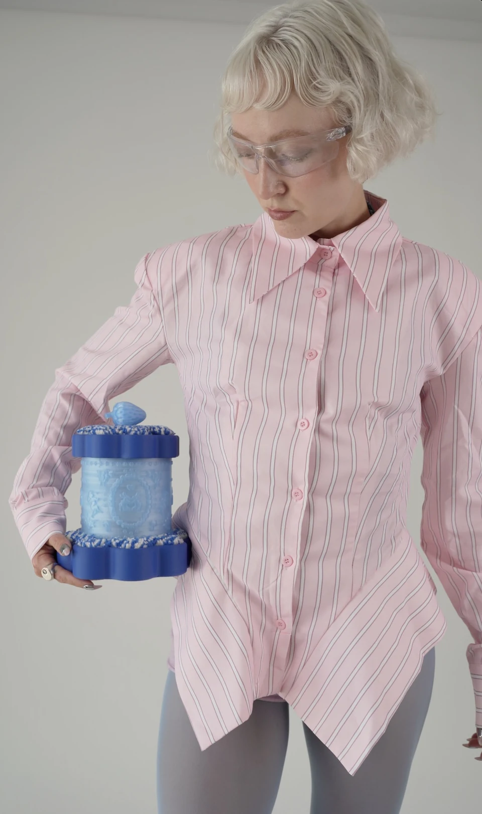 Nadia in a striped pink shirt holding the finished Treasure Box.